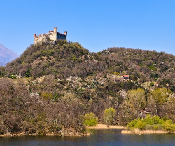 The castle of Montalto Dora, at an altitude of 405 meters, on the Pistono Lake, in the morainic amphitheater of Ivrea, dating back to the mid-12th century.  Clear sunny spring morning